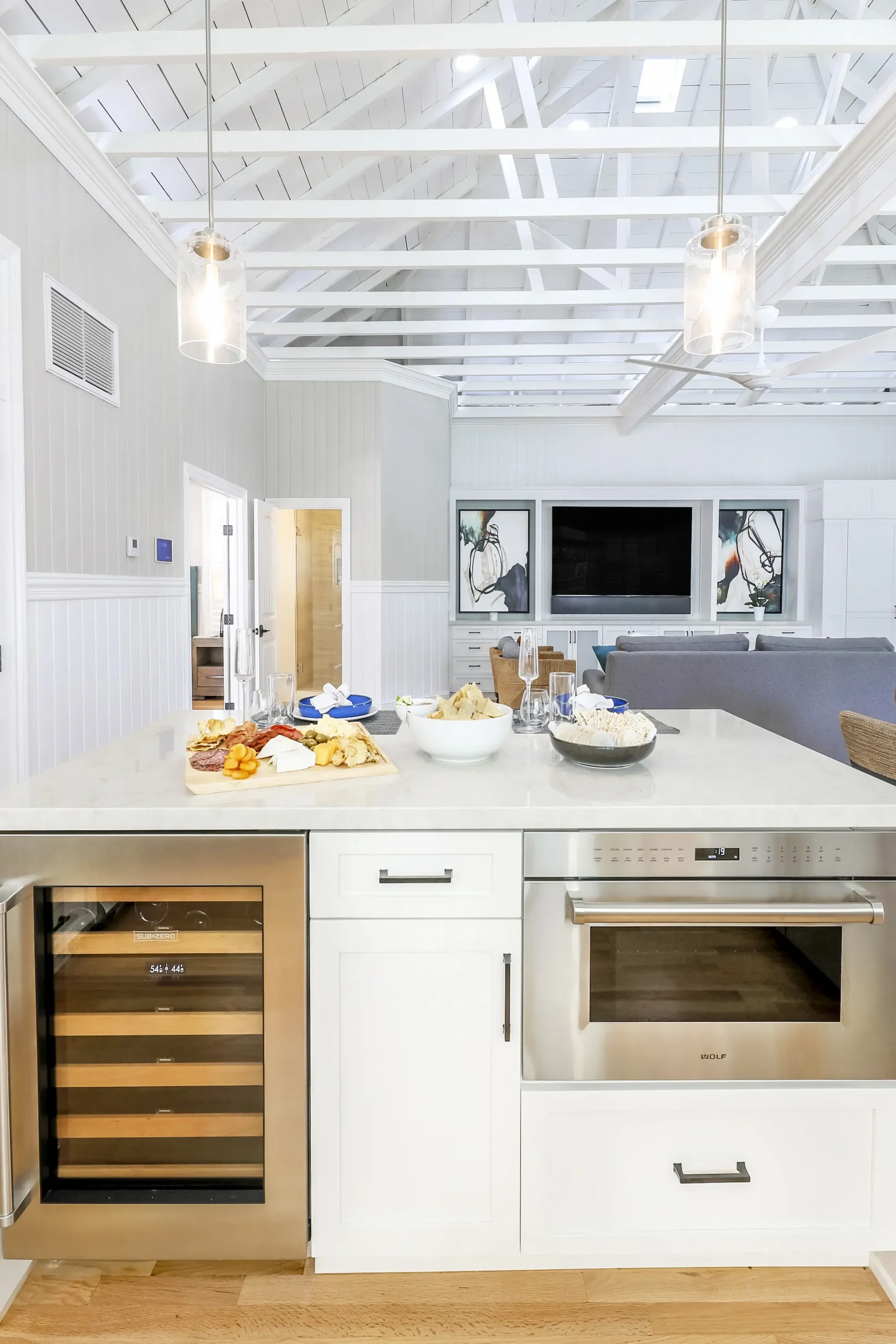 kitchen island with plated snacks and wine fridge