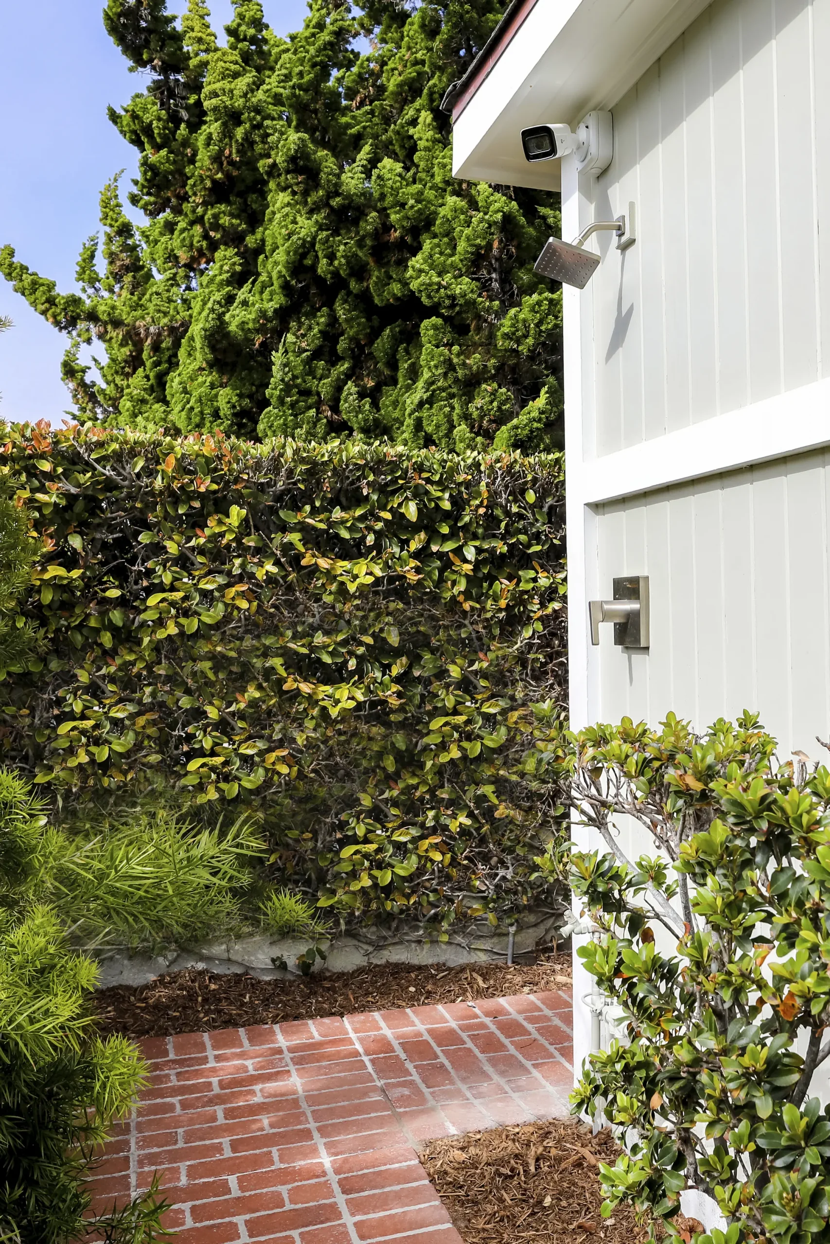 outdoor shower surrounded by bushes